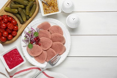 Photo of Tasty beef tongue pieces, berries, red onion and ingredients on white wooden table, flat lay. Space for text