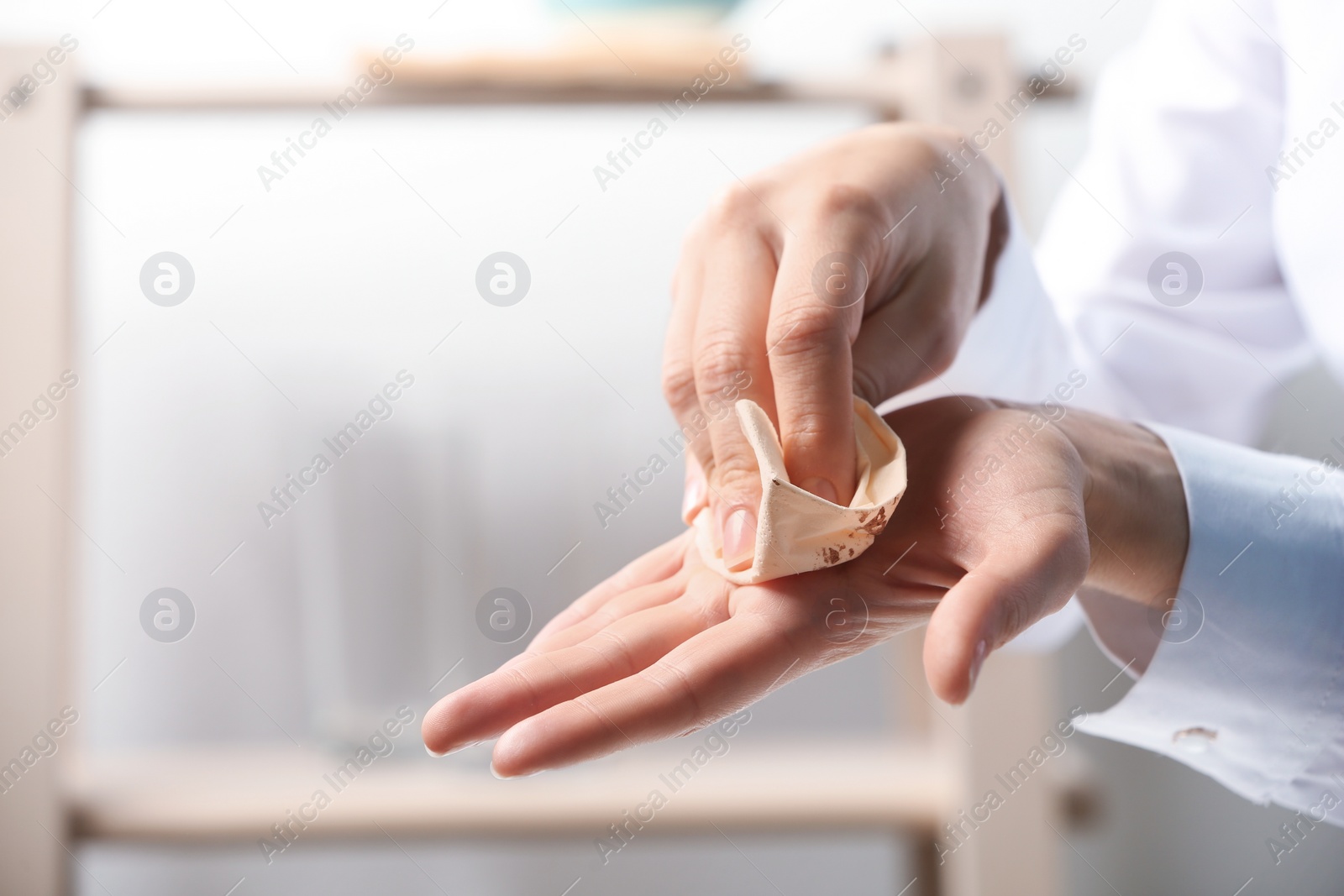 Photo of Woman cleaning hands with paper napkin indoors, closeup