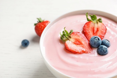 Photo of Bowl with delicious yogurt and berries, closeup