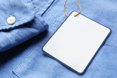 Blank tag on shirt, closeup view. Space for text