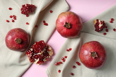 Photo of Flat lay composition with ripe pomegranates on color background