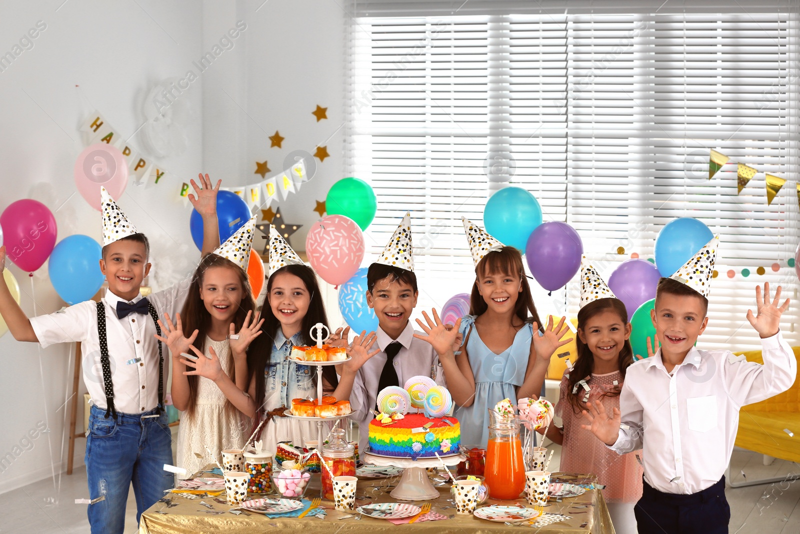 Photo of Happy children at birthday party in decorated room