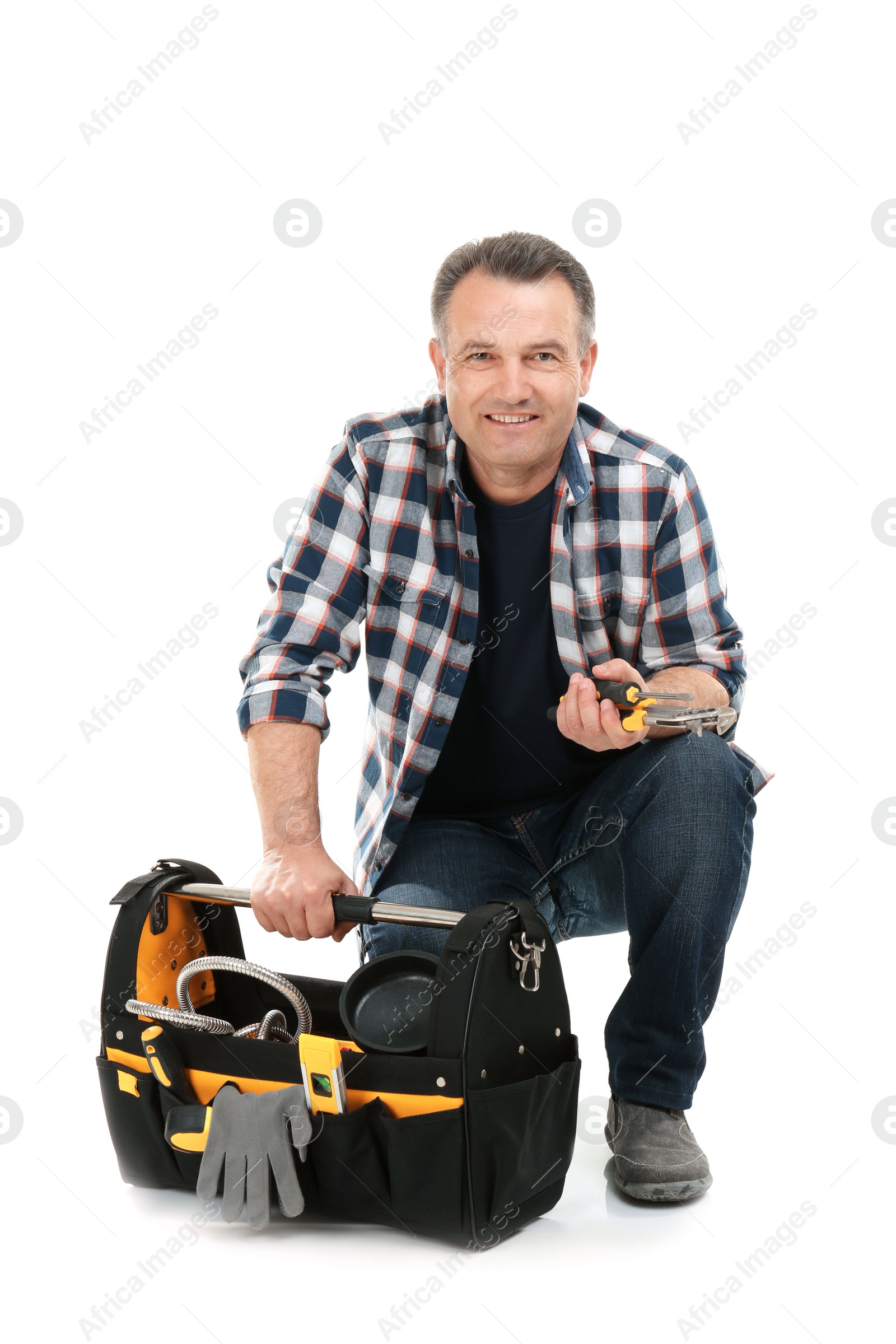 Photo of Mature plumber with tool bag on white background