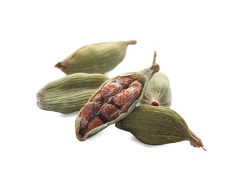 Photo of Pile of dry green cardamom pods on white background