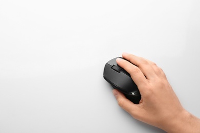 Woman using computer mouse on white background, top view. Space for text