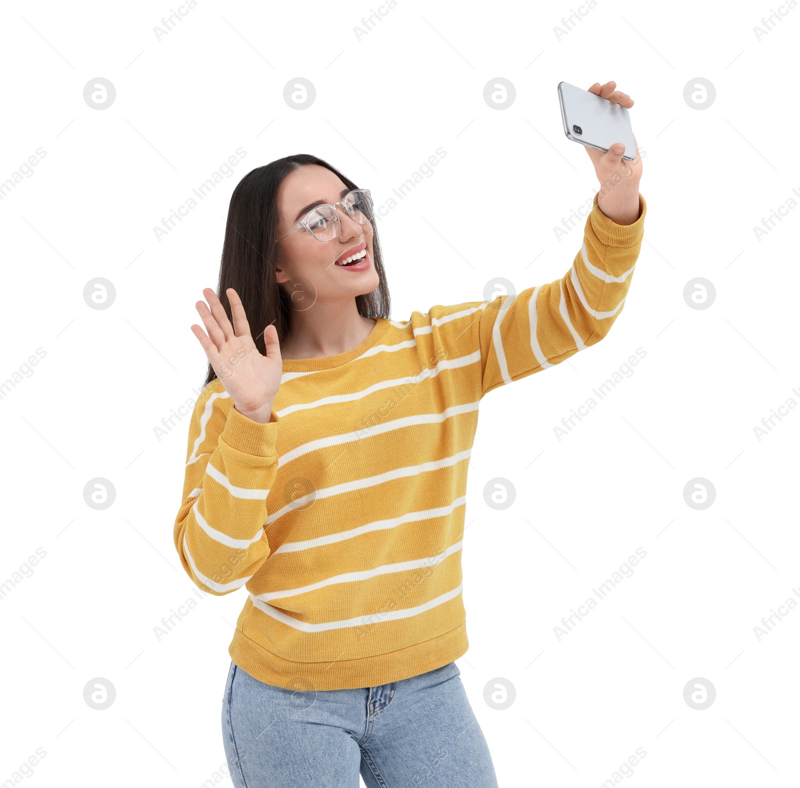 Photo of Smiling young woman taking selfie with smartphone on white background