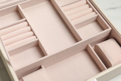 Empty beige jewelry box on table, closeup