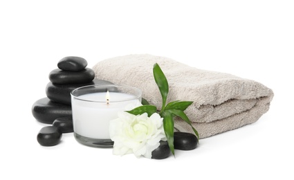 Photo of Beautiful spa composition with candle and stones on white background