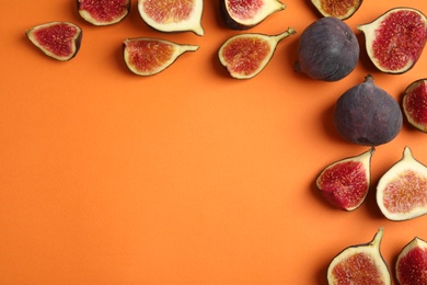 Delicious ripe figs on orange background, flat lay. Space for text