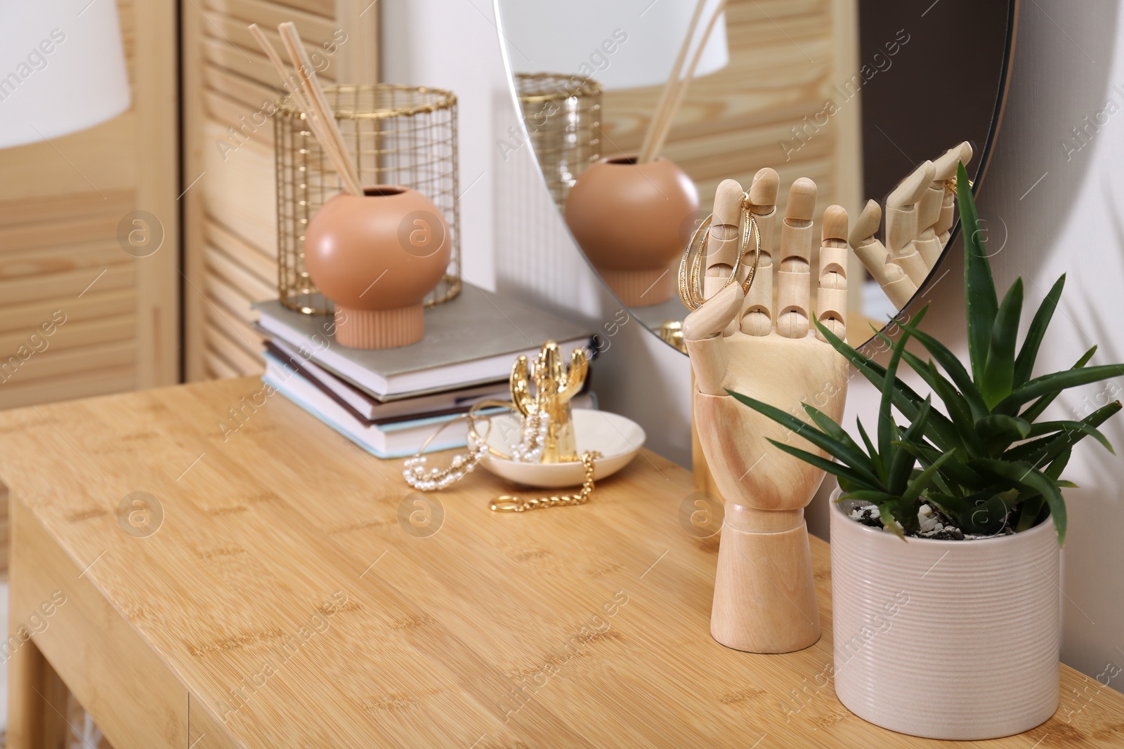 Photo of Decorative elements on wooden dressing table in room