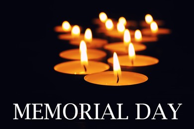 Image of Memorial day. Wax candles burning on black background