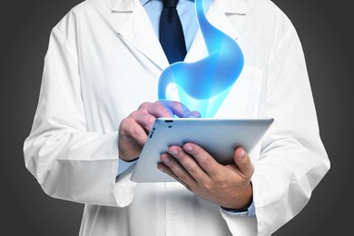 Image of Symptoms and treatment of heartburn and other gastrointestinal diseases. Doctor using tablet on black background, closeup. Stomach illustration over device