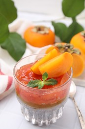 Photo of Delicious dessert with persimmon and chia seeds on table