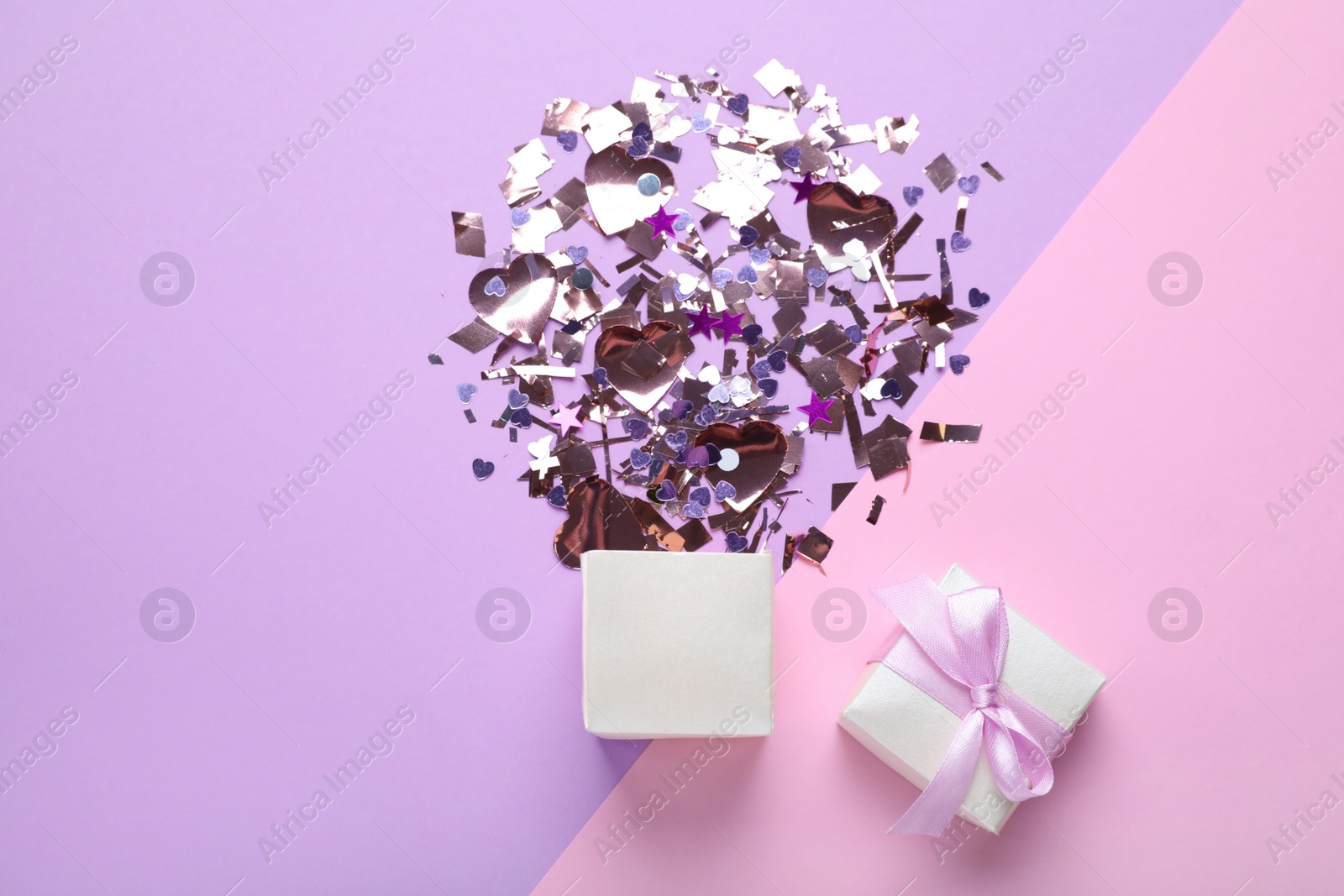 Photo of Flat lay composition with shiny confetti and box on color background