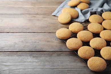 Many tasty sugar cookies on wooden table. Space for text