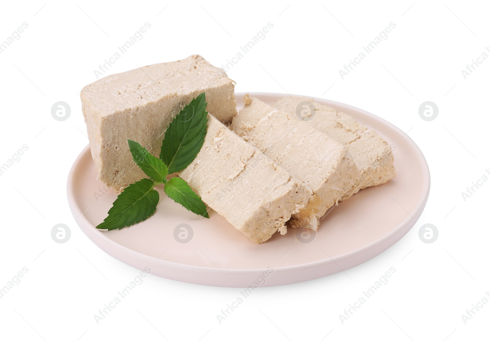 Photo of Plate with pieces of tasty halva and mint isolated on white