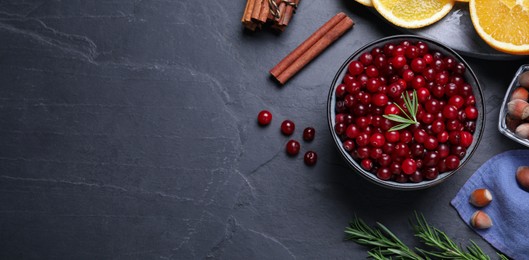 Flat lay composition with fresh ripe cranberries on dark grey table, space for text. Banner design