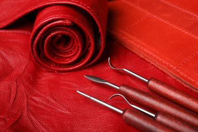 Photo of Set of craftsman tools on leather surface, closeup view, closeup
