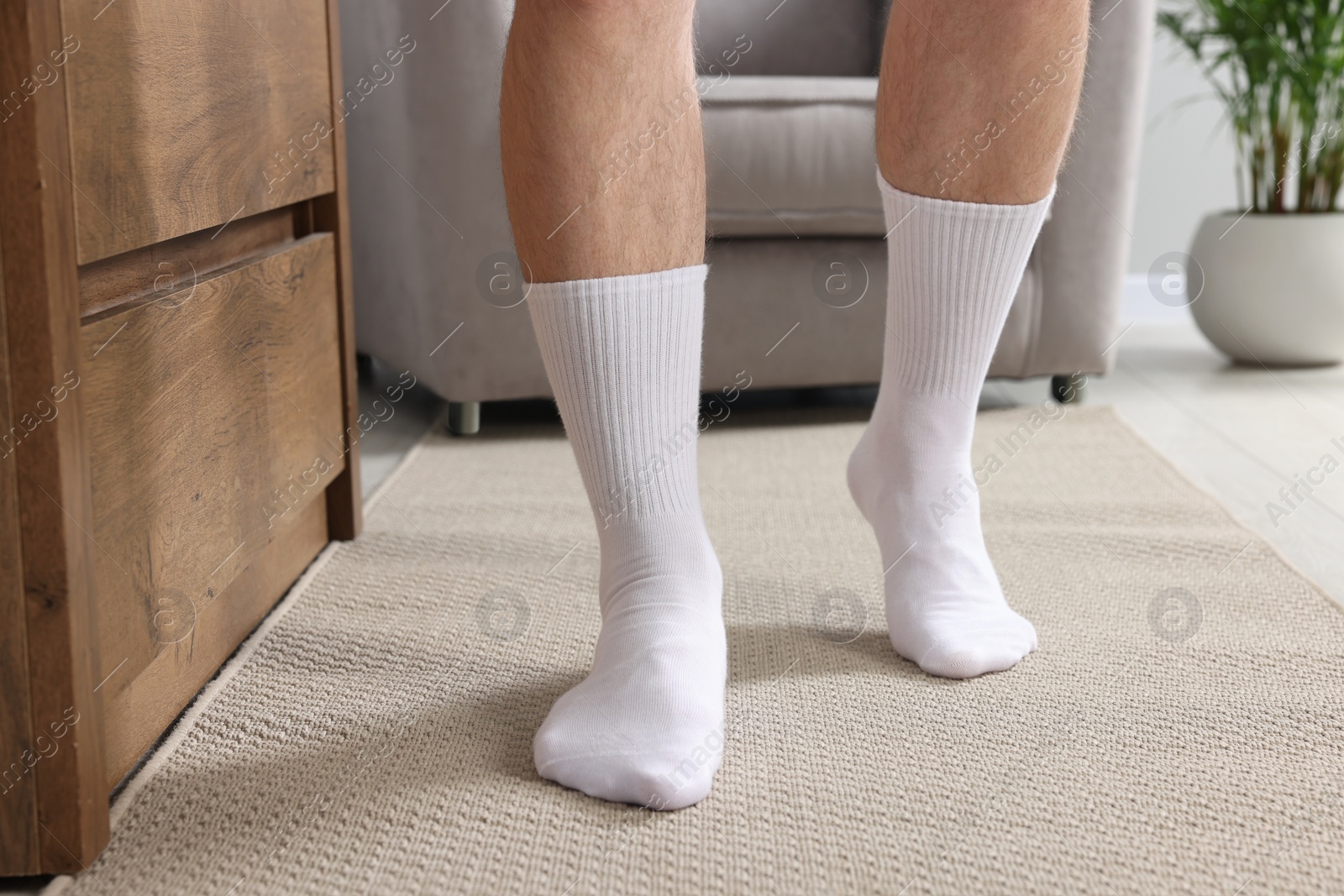 Photo of Man in stylish white socks indoors, closeup