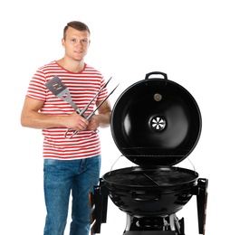 Man with barbecue grill and utensils on white background