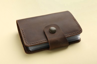 One leather card holder on beige background