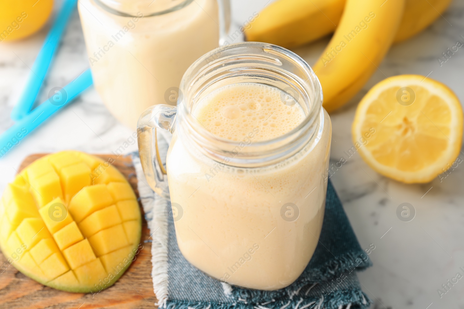 Photo of Mason jars with healthy detox smoothie and ingredients on table