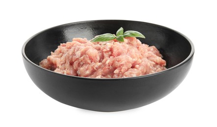 Photo of Raw chicken minced meat with basil in bowl on white background