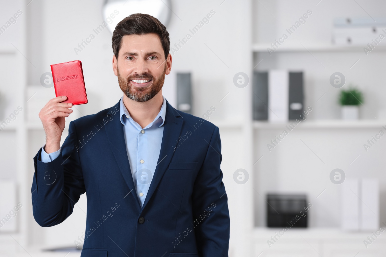 Photo of Immigration. Happy man with passport indoors, space for text