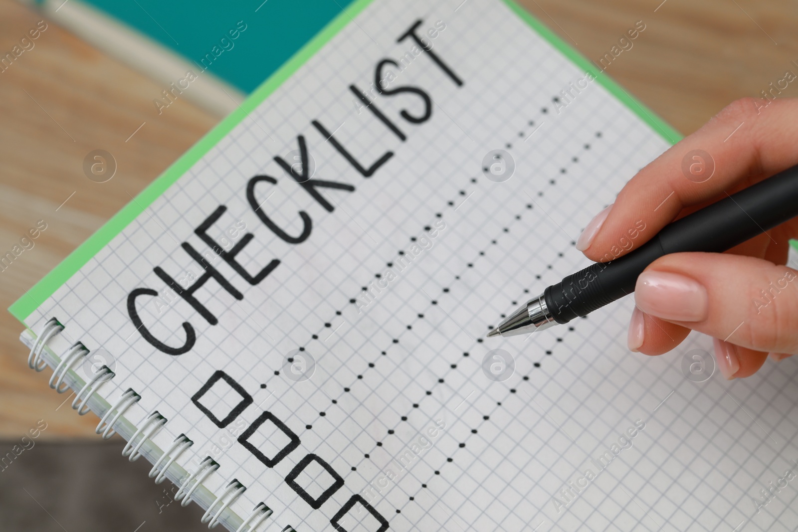 Photo of Woman filling Checklist with pen, closeup view