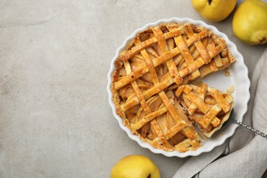 Tasty homemade quince pie with cake server and fresh fruits on light grey table, flat lay. Space for text