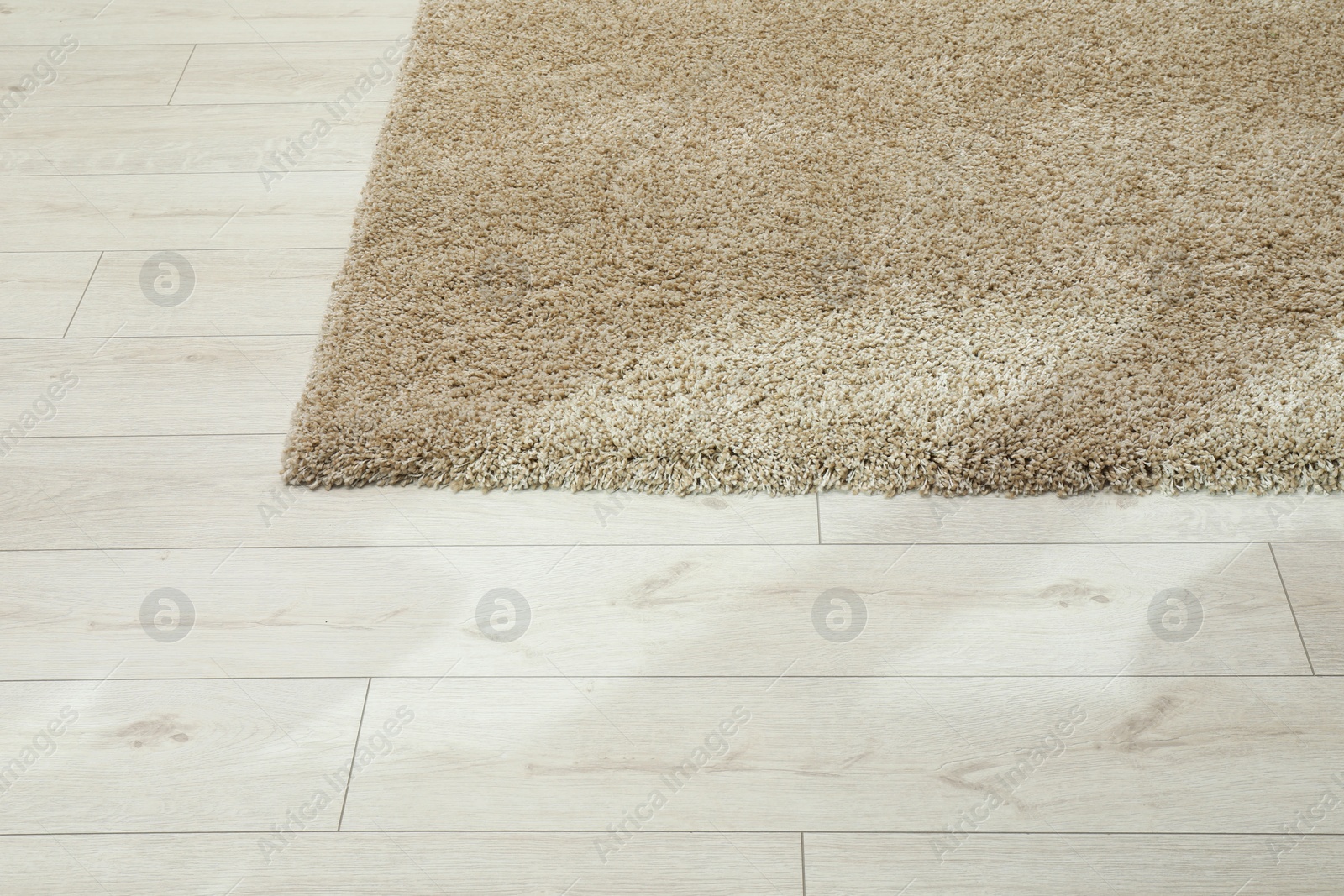 Photo of Soft beige carpet on white laminated floor indoors, space for text