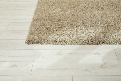 Soft beige carpet on white laminated floor indoors, space for text