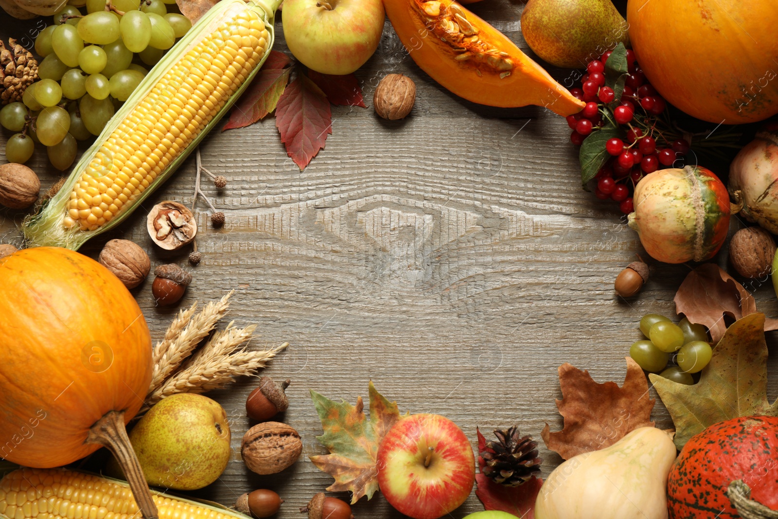 Photo of Frame made of autumn vegetables and fruits on wooden background, top view with space for text. Happy Thanksgiving day