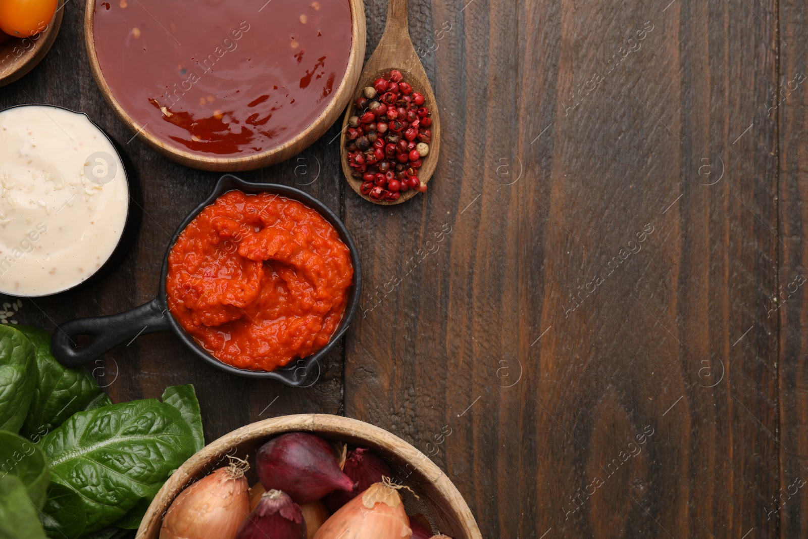 Photo of Different marinades and products on wooden table, flat lay. Space for text