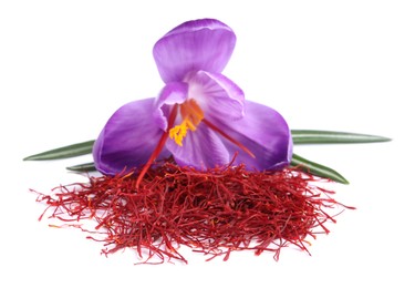 Photo of Pile of dried saffron and crocus flower on white background