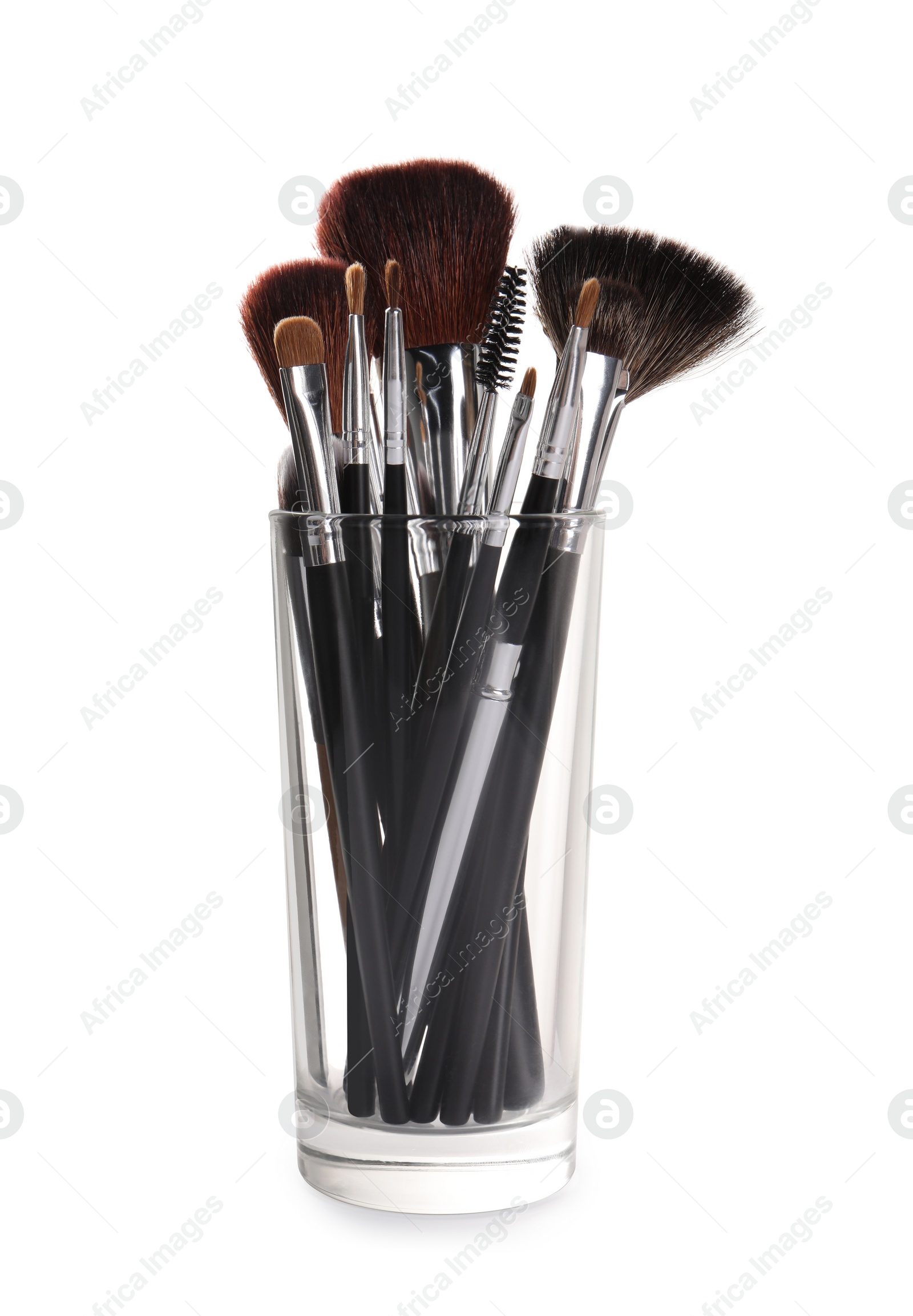 Photo of Glass holder with professional makeup brushes on white background