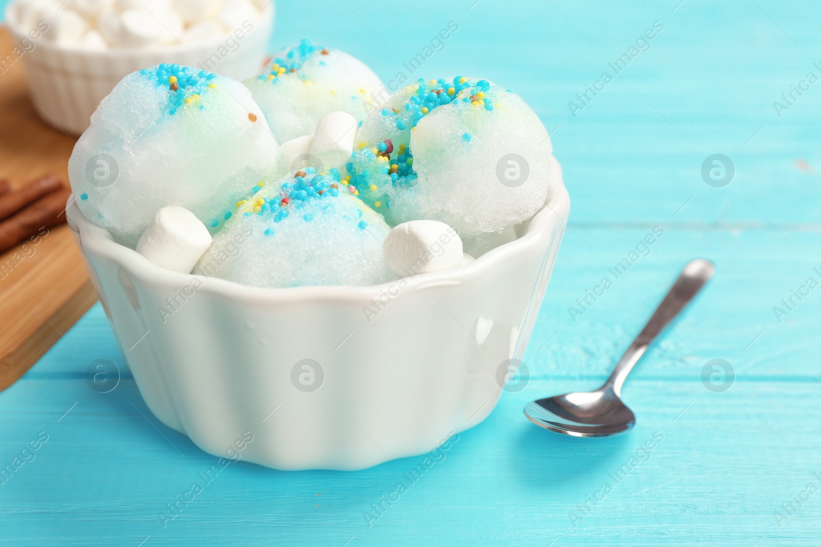 Photo of Bowl of tasty snow ice cream on color wooden table. Space for text