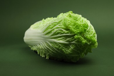 Photo of Fresh ripe Chinese cabbage on green background, closeup