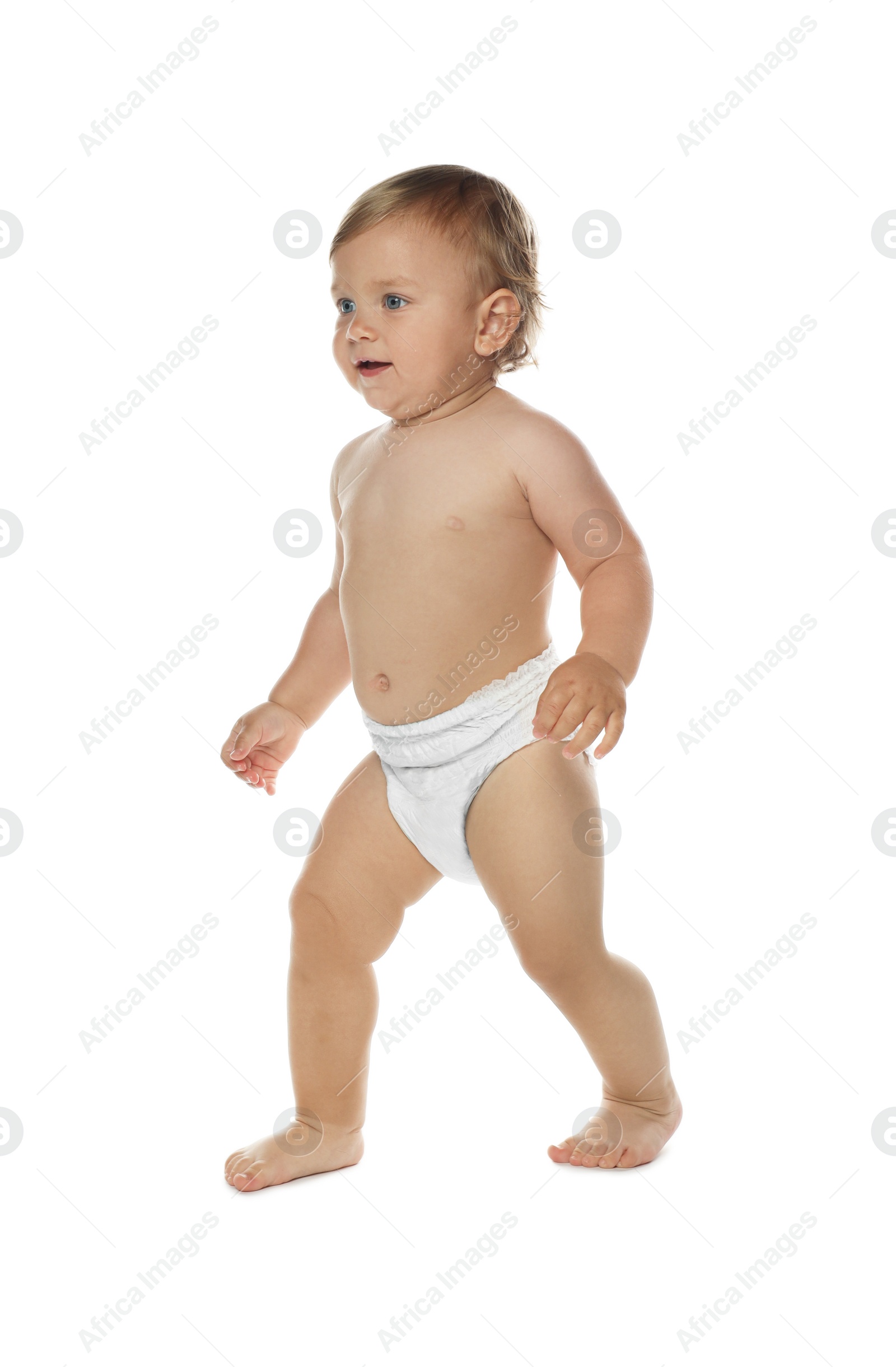 Photo of Cute baby in diaper learning to walk on white background