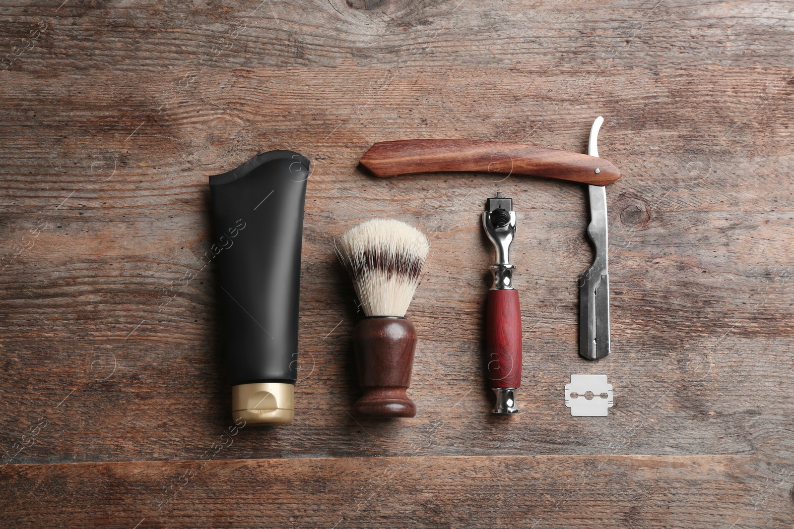 Photo of Flat lay composition with tube of men's cosmetic product on wooden background. Space for design