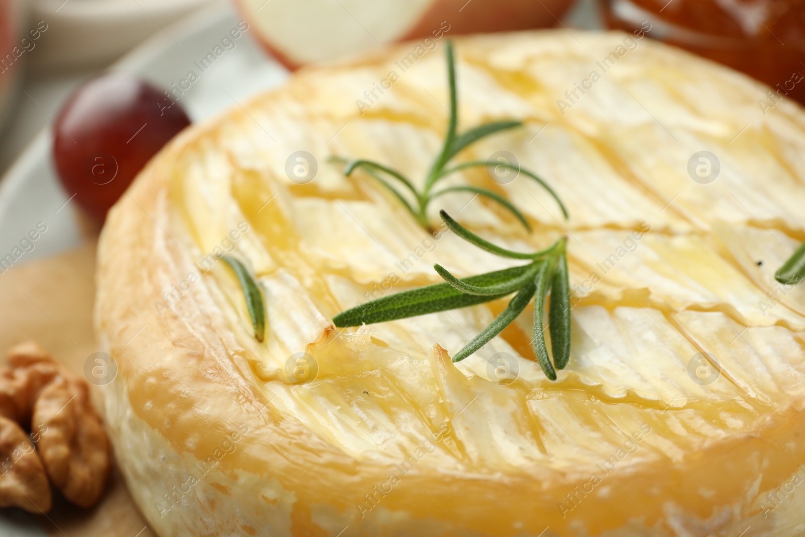 Photo of Tasty baked brie cheese with rosemary, closeup
