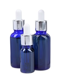 Photo of Blue bottles with tincture isolated on white