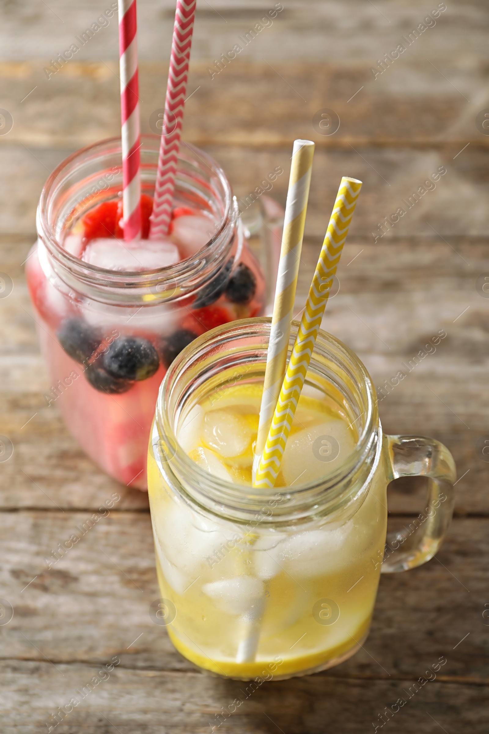 Photo of Natural lemonades in mason jars on wooden table