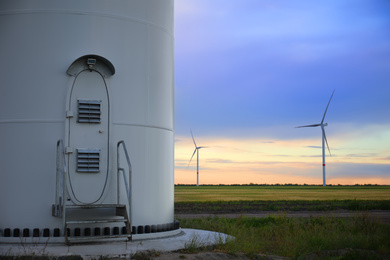 Photo of Entrance to wind turbine power generator outdoors in evening. Alternative energy source