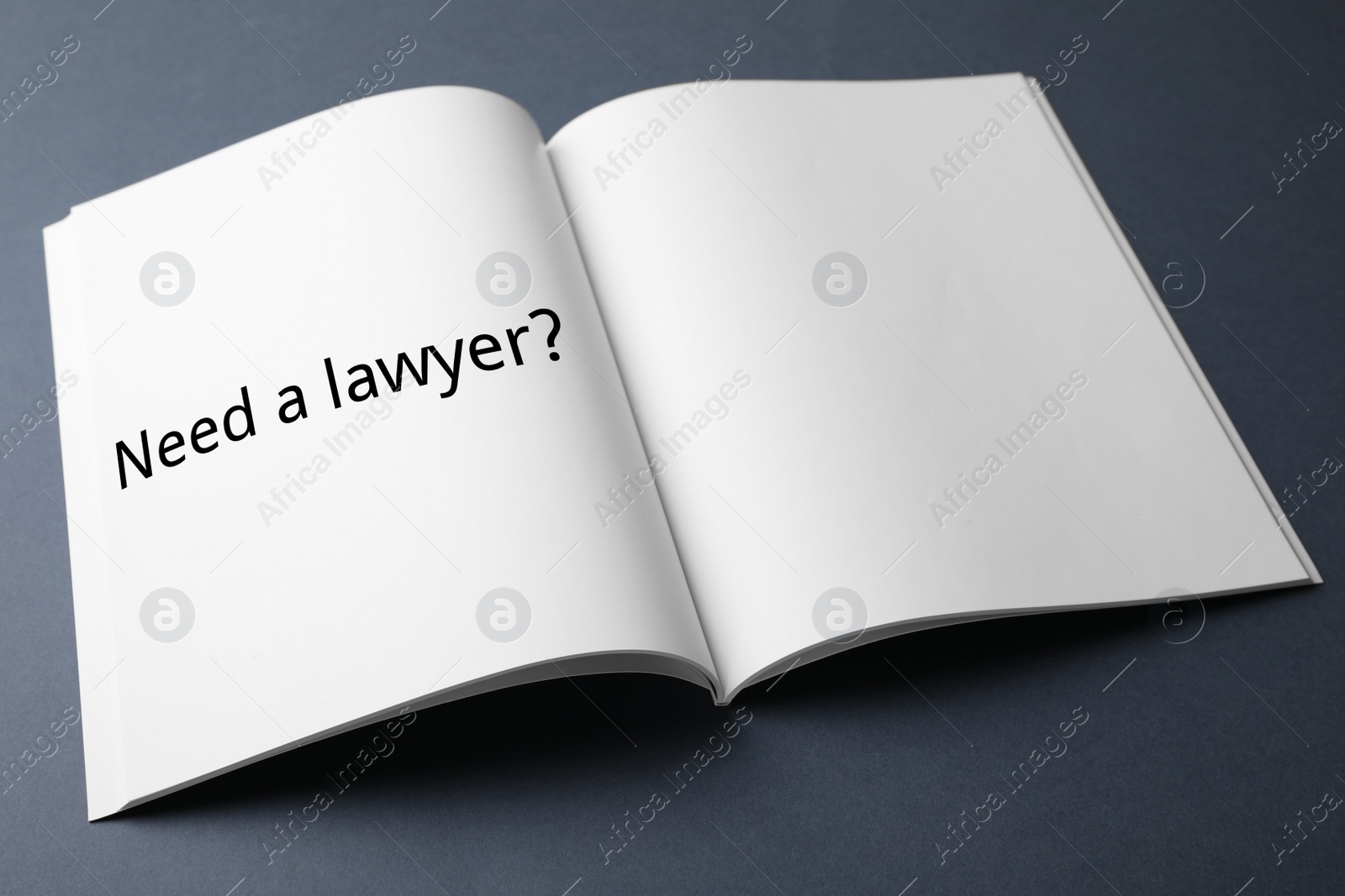 Image of Notebook with text NEED A LAWYER? on dark background