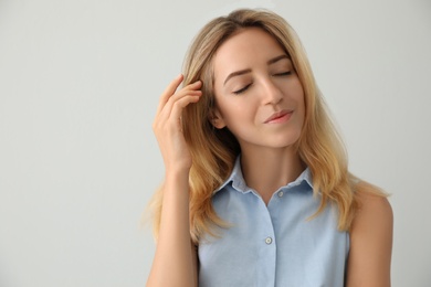 Portrait of beautiful young woman on light background