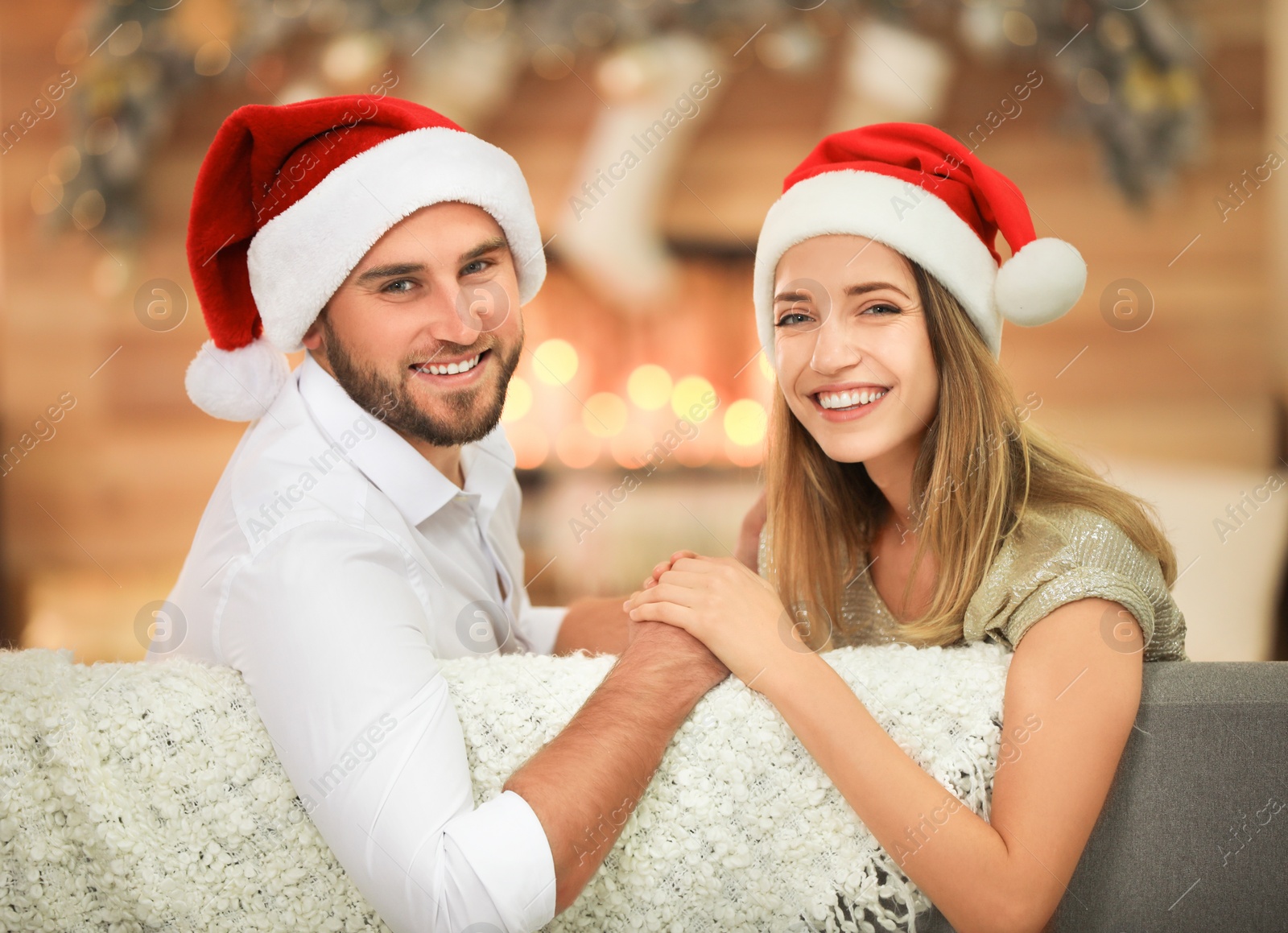 Image of Happy couple in Santa hats. Christmas celebration