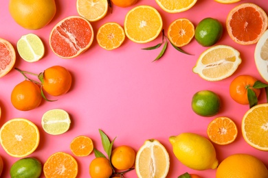 Photo of Frame made of different citrus fruits on color background, top view. Space for text