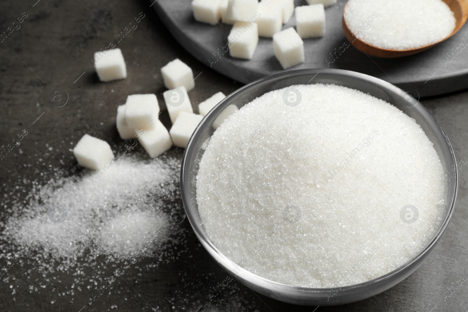 Photo of Composition with granulated sugar on grey table