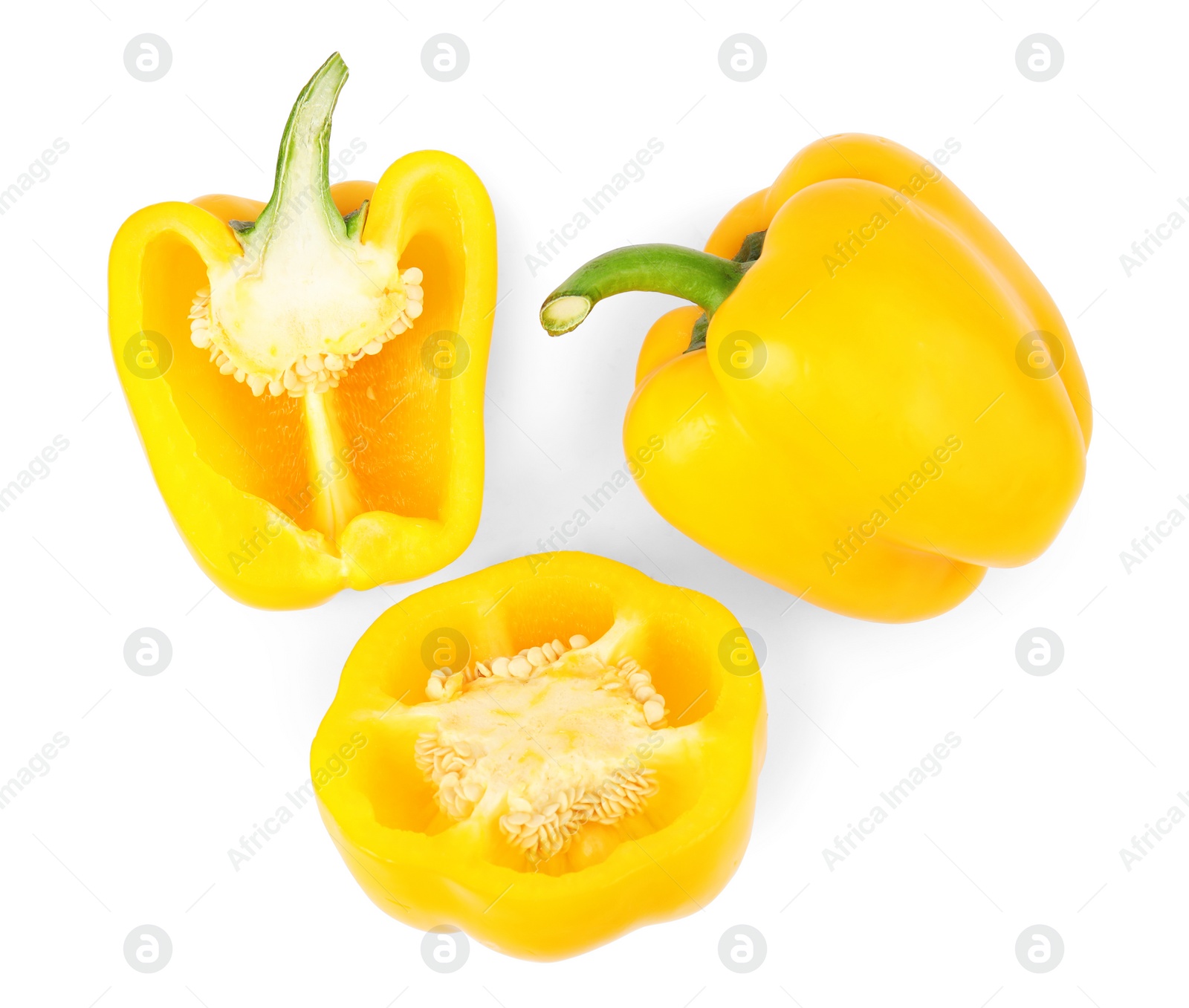 Photo of Whole and cut yellow bell peppers isolated on white